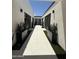 Open air courtyard with modern landscaping, pavers, and artificial turf at 9027 S 19Th St, Phoenix, AZ 85042