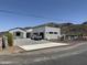 Contemporary home featuring a white stucco exterior, mountain views, and concrete driveway at 9027 S 19Th St, Phoenix, AZ 85042