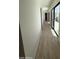 Bright hallway with wood floors and walls of glass leading to an outdoor patio at 9027 S 19Th St, Phoenix, AZ 85042