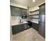 Charming kitchen featuring sage green cabinets, stainless steel appliances, and subway tile backsplash at 9027 S 19Th St, Phoenix, AZ 85042