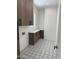 Well-lit laundry room with stylish tile floors and ample cabinet space at 9027 S 19Th St, Phoenix, AZ 85042