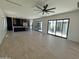 Open-concept living room with hardwood floors, modern ceiling fan, and sliding doors to outdoor space at 9027 S 19Th St, Phoenix, AZ 85042