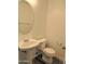 Efficient bathroom showcasing a pedestal sink and toilet, ideal for compact spaces with laminate flooring at 9233 E Neville Ave # 1011, Mesa, AZ 85209