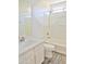 Bright bathroom featuring a tub-shower combination and a sleek white vanity with stylish gray laminate flooring at 9233 E Neville Ave # 1011, Mesa, AZ 85209