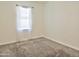 Carpeted bedroom with a window that brings in natural light, dressed with breezy, sheer white curtains at 9233 E Neville Ave # 1011, Mesa, AZ 85209