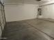 A clean, spacious garage with sealed concrete flooring and a modern, energy-efficient water heater at 9233 E Neville Ave # 1011, Mesa, AZ 85209