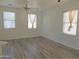 Open living room filled with natural light, featuring laminate floors and neutral color scheme at 9233 E Neville Ave # 1011, Mesa, AZ 85209