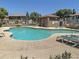 Community pool surrounded by sun loungers, native shrubs and landscaping, perfect for relaxation and socializing at 9233 E Neville Ave # 1011, Mesa, AZ 85209