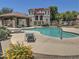 Sparkling community pool with a shaded pavilion and lounge chairs, set amidst lush landscaping at 9233 E Neville Ave # 1011, Mesa, AZ 85209