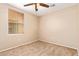 A bedroom with a ceiling fan, blinds, and neutral-colored walls and carpet at 9233 E Neville Ave # 1127, Mesa, AZ 85209