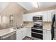 Efficient kitchen with white cabinetry and stainless steel appliances at 9233 E Neville Ave # 1127, Mesa, AZ 85209