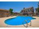A community pool with lounge chairs, surrounded by apartments and a bathroom/changing room at 9233 E Neville Ave # 1127, Mesa, AZ 85209