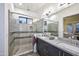 Bathroom featuring a glass-enclosed shower, dual sinks, and modern gray cabinetry at 1 Easy St # 17, Carefree, AZ 85377