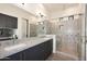 Modern bathroom features dual sinks, granite countertops, and a glass-enclosed shower at 1 Easy St # 17, Carefree, AZ 85377