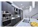 Modern kitchen features stainless steel appliances, sleek gray cabinetry, and island at 1 Easy St # 17, Carefree, AZ 85377