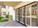 Private back patio with shuttered sliding doors and beautiful flowering landscaping at 10330 W Thunderbird Blvd # B112, Sun City, AZ 85351