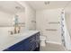 Bathroom with a modern vanity, brushed gold faucet, and shower with patterned curtain at 10330 W Thunderbird Blvd # B112, Sun City, AZ 85351