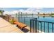 Inviting community lake view with a bench and fence, perfect for relaxing and enjoying the scenery at 10330 W Thunderbird Blvd # B112, Sun City, AZ 85351
