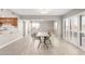 Open-concept dining room area featuring tile flooring and ample natural light from patio doors at 10330 W Thunderbird Blvd # B112, Sun City, AZ 85351