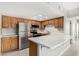 Bright kitchen featuring stainless steel appliances, white countertops and oak cabinetry at 10330 W Thunderbird Blvd # B112, Sun City, AZ 85351