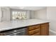 Bright kitchen island with white counters and wooden cabinets, offering space for seating at 10330 W Thunderbird Blvd # B112, Sun City, AZ 85351