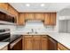 Well-equipped kitchen featuring stainless steel appliances, white countertops, and oak cabinets at 10330 W Thunderbird Blvd # B112, Sun City, AZ 85351