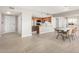 Spacious and well-lit open-concept living space with modern tile flooring, adjacent to the kitchen and dining area at 10330 W Thunderbird Blvd # B112, Sun City, AZ 85351