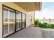 Cozy patio area with sliding glass doors and views of the nearby lake and landscaping at 10330 W Thunderbird Blvd # B112, Sun City, AZ 85351