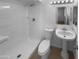 Bathroom featuring a walk-in shower, white walls, and a pedestal sink at 10831 W Heatherbrae Dr, Phoenix, AZ 85037