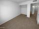 Bedroom featuring neutral carpet, closet, and neutral colored walls at 10831 W Heatherbrae Dr, Phoenix, AZ 85037