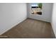 Cozy bedroom featuring neutral carpeting and a window that fills the room with natural light at 10831 W Heatherbrae Dr, Phoenix, AZ 85037