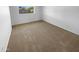 Bedroom with neutral carpet, a window, and neutral colored walls at 10831 W Heatherbrae Dr, Phoenix, AZ 85037