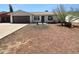 Charming single-story home boasts a well-kept lawn and an inviting facade at 10831 W Heatherbrae Dr, Phoenix, AZ 85037
