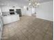 Open floorplan with view of kitchen featuring stainless appliances, white cabinetry, and a large island at 10831 W Heatherbrae Dr, Phoenix, AZ 85037