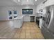 Modern kitchen boasts stainless steel appliances, a sleek countertop, and ample cabinet space at 10831 W Heatherbrae Dr, Phoenix, AZ 85037