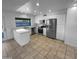 Bright kitchen features white cabinets, stainless steel appliances, and an island with a white countertop at 10831 W Heatherbrae Dr, Phoenix, AZ 85037