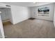 A well-lit living room showcases a spacious layout and new neutral carpeting at 10831 W Heatherbrae Dr, Phoenix, AZ 85037