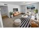 Bright living room is furnished with modern decor, a stylish rug, and contemporary furniture at 10831 W Heatherbrae Dr, Phoenix, AZ 85037