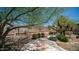 Serene desert backyard featuring natural landscaping, mature trees, and stone accents at 116 E Mountain Sky Ave, Phoenix, AZ 85048