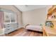 Bright bedroom with vaulted ceiling, wood floors, dresser, and a light color scheme at 116 E Mountain Sky Ave, Phoenix, AZ 85048