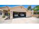Two car garage with vehicles parked inside and curb appeal including manicured landscaping at 116 E Mountain Sky Ave, Phoenix, AZ 85048