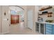 Hallway leading to a bar, with tiled floors and natural lighting at 116 E Mountain Sky Ave, Phoenix, AZ 85048