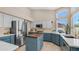 Bright kitchen with a center island, stainless steel appliances, and two-tone cabinetry at 116 E Mountain Sky Ave, Phoenix, AZ 85048