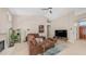 Bright living room with a fireplace, ceiling fan, and a comfortable sectional sofa at 116 E Mountain Sky Ave, Phoenix, AZ 85048
