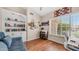Comfortable living room featuring built-in shelves, bright windows, and hardwood floors at 116 E Mountain Sky Ave, Phoenix, AZ 85048