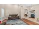 Spacious living room featuring hardwood floors, an open doorway, and an area rug at 116 E Mountain Sky Ave, Phoenix, AZ 85048