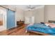Bright main bedroom with hardwood floors and a barn door leading to a bath at 116 E Mountain Sky Ave, Phoenix, AZ 85048