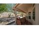 Covered patio with dining set, offering scenic backyard desert views at 116 E Mountain Sky Ave, Phoenix, AZ 85048