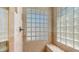 Beautiful enclosed shower featuring glass block windows and a built-in bench at 116 E Mountain Sky Ave, Phoenix, AZ 85048
