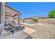 Spacious backyard featuring a pool, patio with lounge chairs, and desert landscaping at 11952 W Villa Chula Ln, Sun City, AZ 85373
